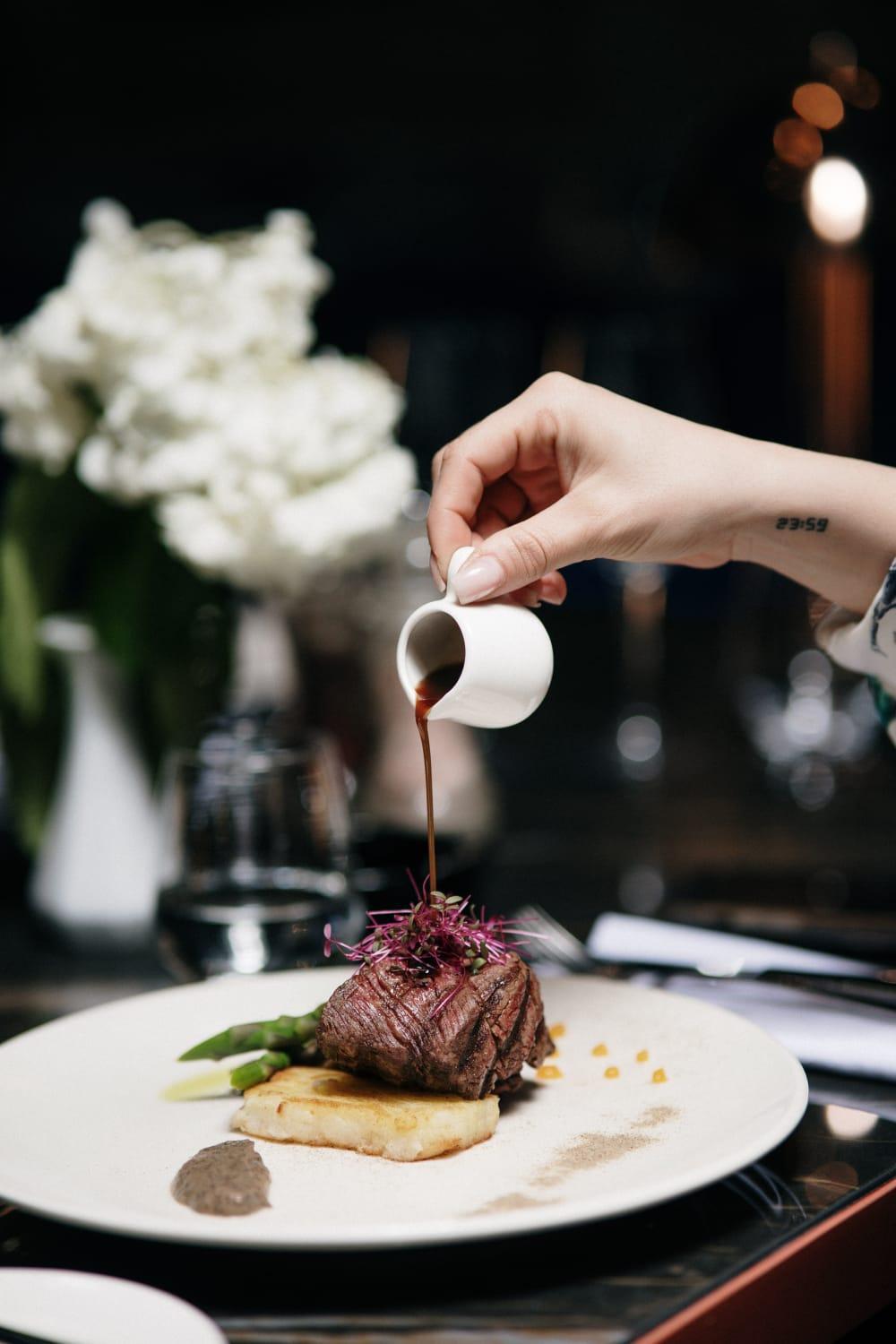 Xheko Imperial Luxury Hotel & Spa ติรานา ภายนอก รูปภาพ A server pours soy sauce onto a dish